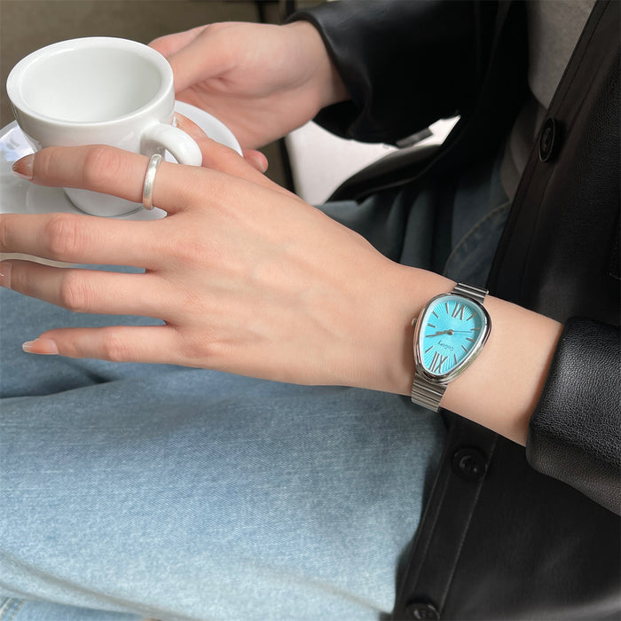 Person wearing a watch with a blue face, holding a white mug.
