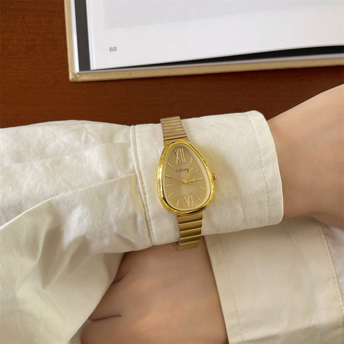 Gold wristwatch on a person's wrist with a white shirt sleeve.