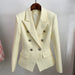 Cream-colored blazer with silver buttons on a hanger against a plain background