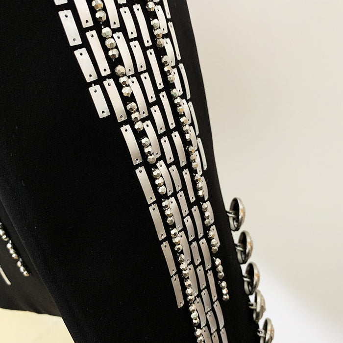 Black jacket with silver chain details on a light gray background