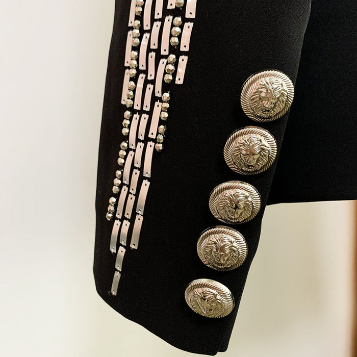 Black jacket with silver buttons and decorative elements on a light background