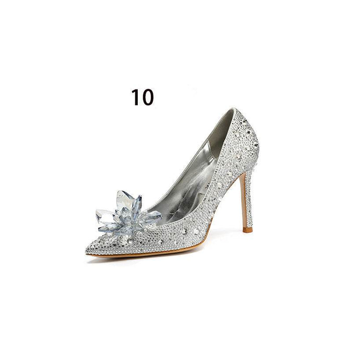 Silver high-heeled shoe with crystal embellishments on a white background