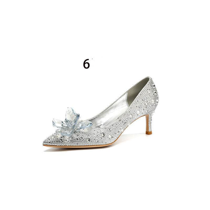 Silver high-heeled shoe with crystal flower design on a white background