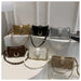 Six small shoulder bags in different colors are arranged on white display risers. The bags include metallic gold, black, silver, brown, off-white, and taupe, with chain straps, studded details, and flap closures.