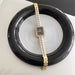 Gold and pearl watch on a black dish