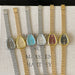 Six vintage-style wristwatches with metal straps on a textured surface.