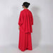 A woman viewed from the back wearing a bright red two-piece outfit with a loose long-sleeve top and matching wide-leg pants, standing against a plain light gray studio background.