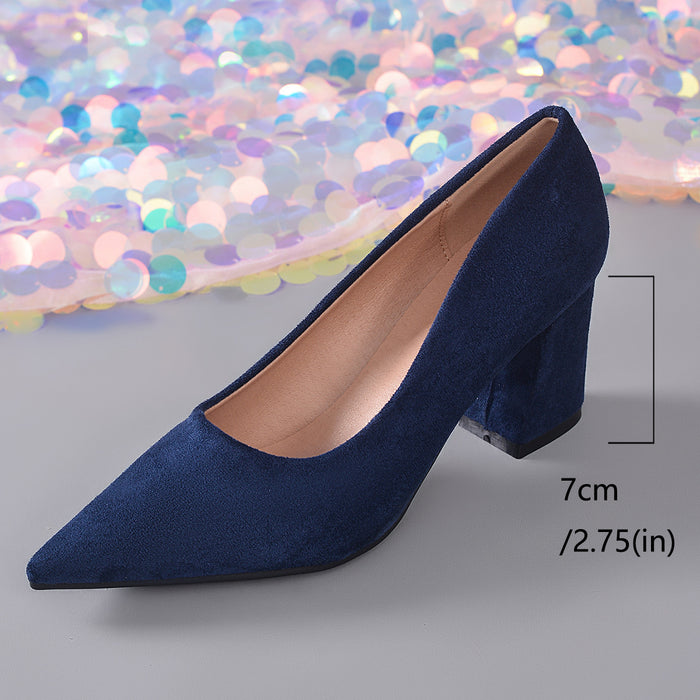 A single navy blue suede pump with a pointed toe and block heel, shown on a gray surface with a decorative iridescent sequin backdrop. A measurement marker indicates the heel height as 7cm (2.