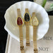 Three gold watches on a white ceramic dish with a blurred background