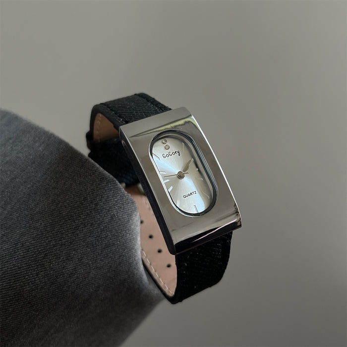 Wristwatch with black strap and silver case on a neutral background