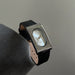 Wristwatch with black strap and silver case on a neutral background