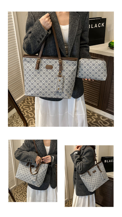 A woman models a large tote bag and a matching zip pouch in a home setting. The tote bag has a gray and white geometric lattice pattern with brown handles and trim, and the pouch is a matching light gray and white patterned fabric.