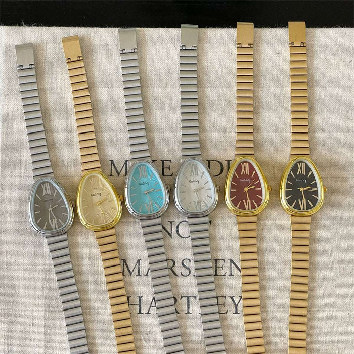 Set of watches with different colored faces on a textured surface