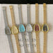 Set of watches with different colored faces on a textured surface
