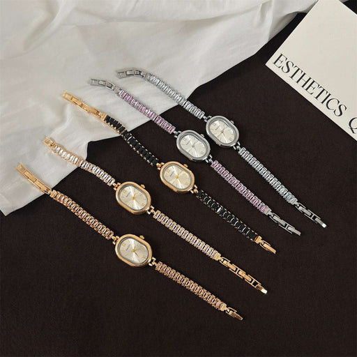 Set of five decorative hairpins with clock faces on a black surface