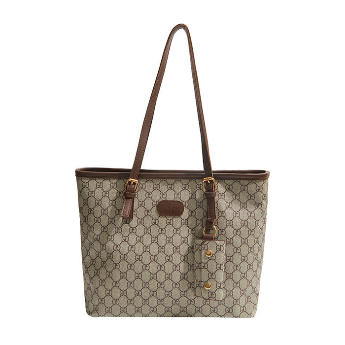A Gucci tote bag in beige GG Supreme canvas with brown leather trim, double shoulder straps, and gold-tone hardware, shown against a plain white background.