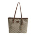 A Gucci tote bag in beige GG Supreme canvas with brown leather trim, double shoulder straps, and gold-tone hardware, shown against a plain white background.