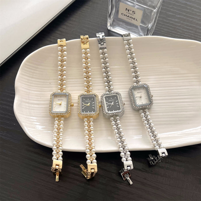 Four pearl-wrapped wrist watches on a white plate with a Chanel perfume bottle in the background.