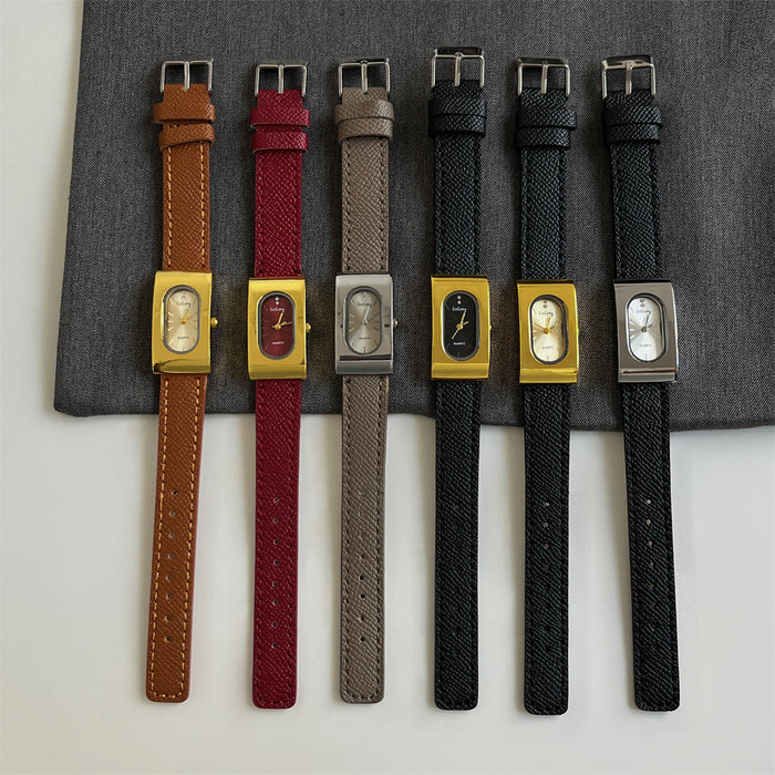 Set of six watches with different colored straps on a gray surface