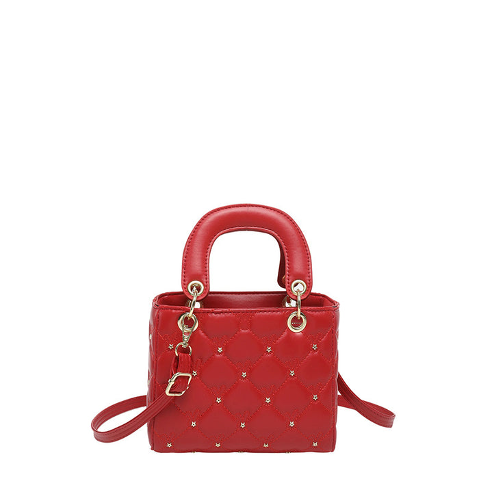 A red quilted leather top-handle handbag with gold-tone hardware and a matching shoulder strap, shown on a plain white background.