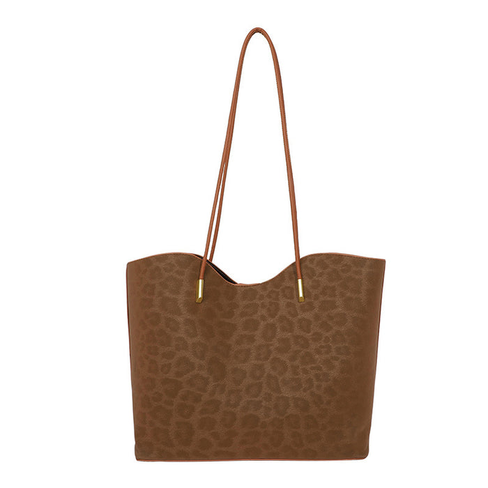 A brown tote bag with a subtle leopard print pattern and matching brown shoulder straps, shown against a plain white background.