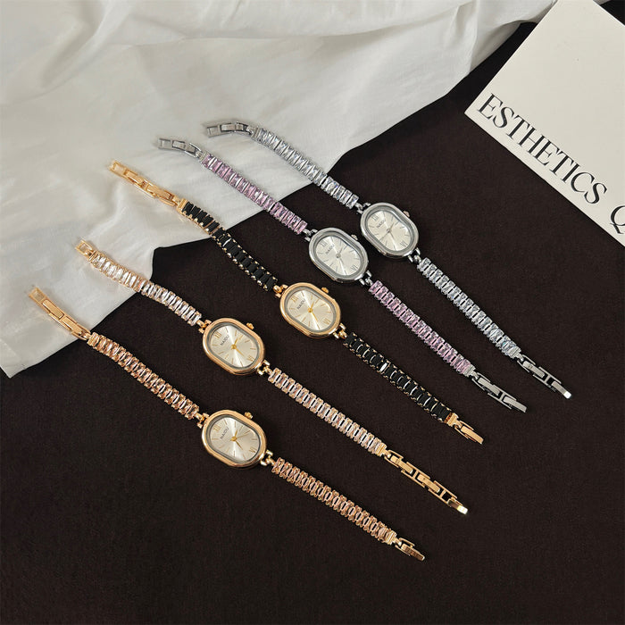 Set of five decorative hairpins with clock faces on a black surface