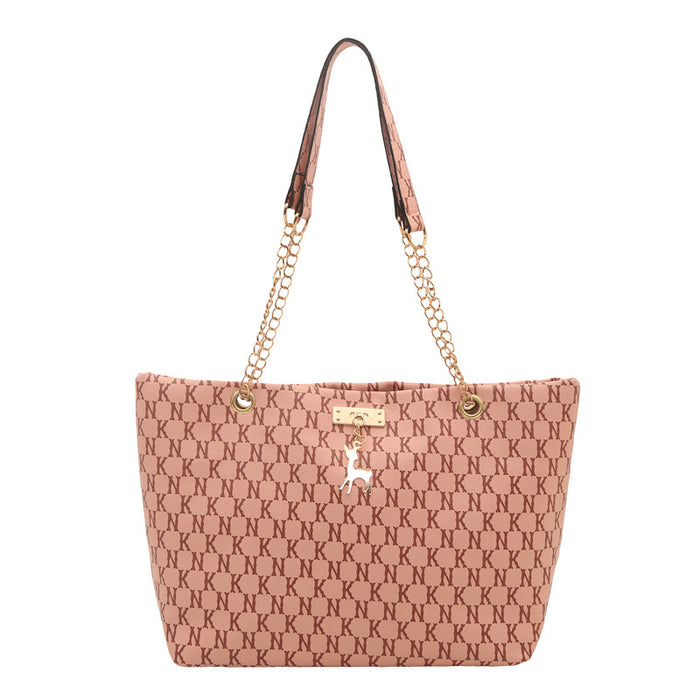 A pink tote bag with an allover dark pink monogram pattern, featuring a gold-tone chain strap, a single leather shoulder strap, and a small deer emblem on the front.