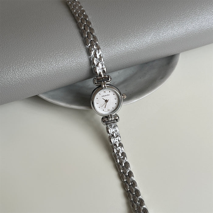 Silver bracelet watch on a gray surface