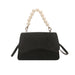 Black handbag with pearl handle on a white background