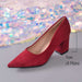 A red suede high-heeled shoe with a pointed toe and block heel, shown on a gray surface with a sequined backdrop and a 7 cm heel height measurement overlay.