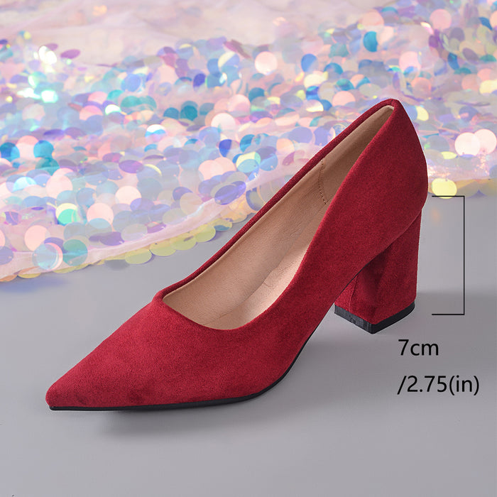 A red suede high-heeled shoe with a pointed toe and block heel, shown on a gray surface with a sequined backdrop and a 7 cm heel height measurement overlay.