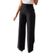 Black wide-leg pants worn by a person on a white background