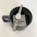 Silver watch with a Chanel Paris tag inside a black mug on a white background