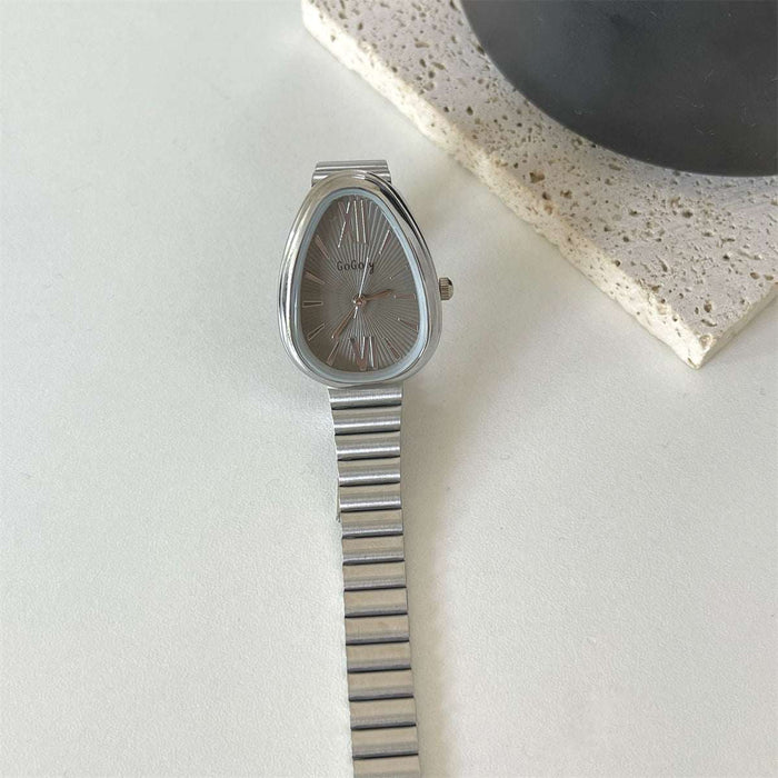 Silver watch with a metallic band on a light surface