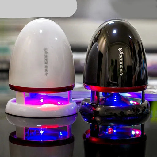 Two small electronic devices with LED lights on a reflective surface.