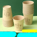Three stacks of beige paper cups with bamboo illustrations, shown on a green background with Chinese text overlays at the bottom.