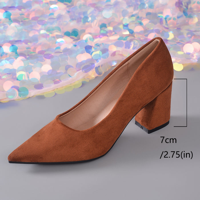 A single brown suede high-heeled shoe with a pointed toe and block heel, shown on a gray surface with a colorful sequin backdrop. A measurement marker indicates the heel is 7 cm (2.