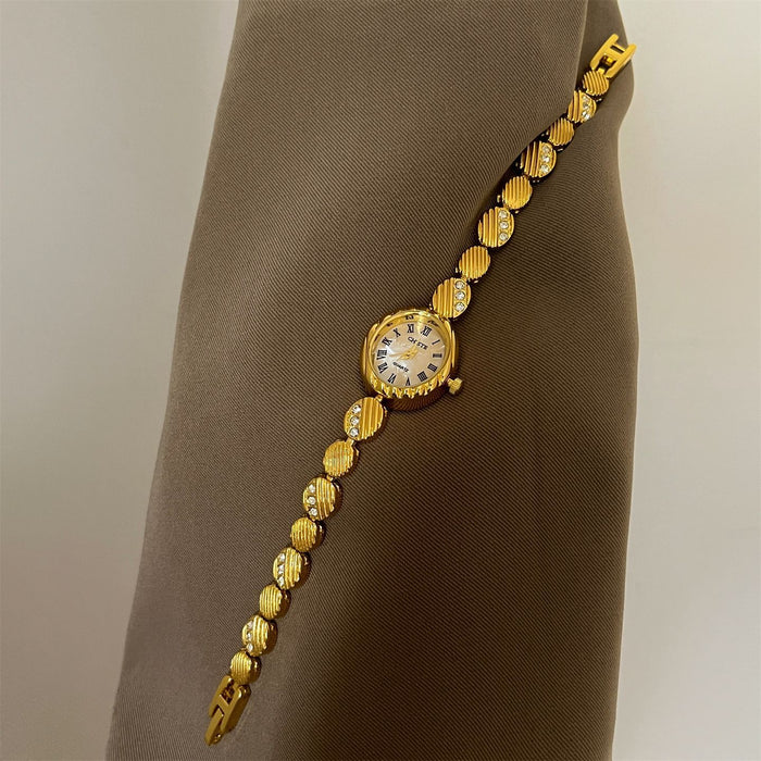 Gold bracelet with a watch face on a brown mannequin