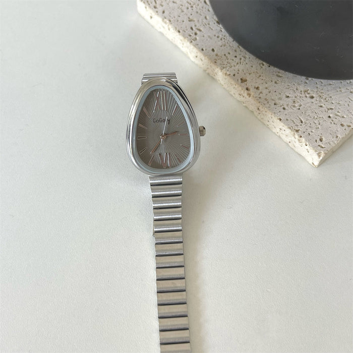 Silver watch with a metallic band on a light surface