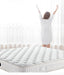 Woman standing on a white mattress with text about sleep quality.