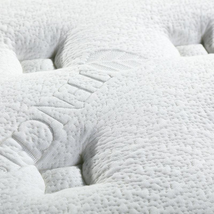 Close-up of a textured white mattress pad