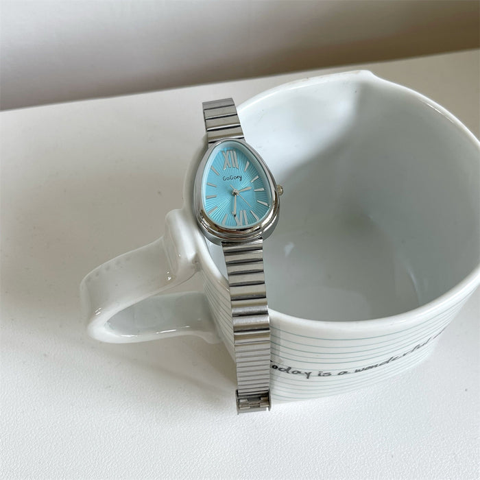 Silver watch with a blue face on a white surface