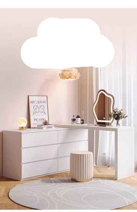 Modern white dresser with mirror and decorative items in a room setting.