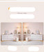 White vanity with mirror and decorative items on a light pink background