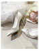 White wedding shoes with embellishments on a light background