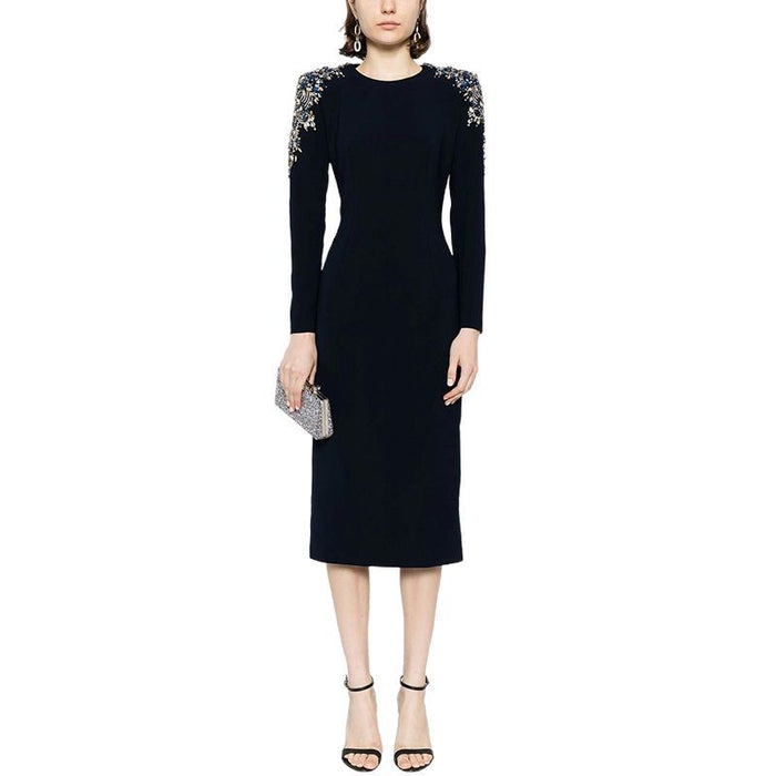Black dress with floral embellishments on sleeves against a white background