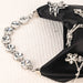 Bracelet with star-shaped crystal embellishments on a black satin bag.