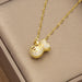 A gold chain necklace with a money bag pendant, heavily embellished with clear crystals, resting on a textured beige jewelry box.
