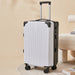 White suitcase with black accents on a beige background