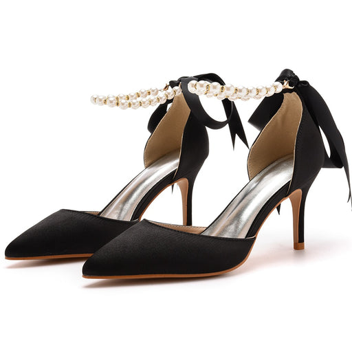 Black high-heeled shoes with bow and pearl detail on a white background